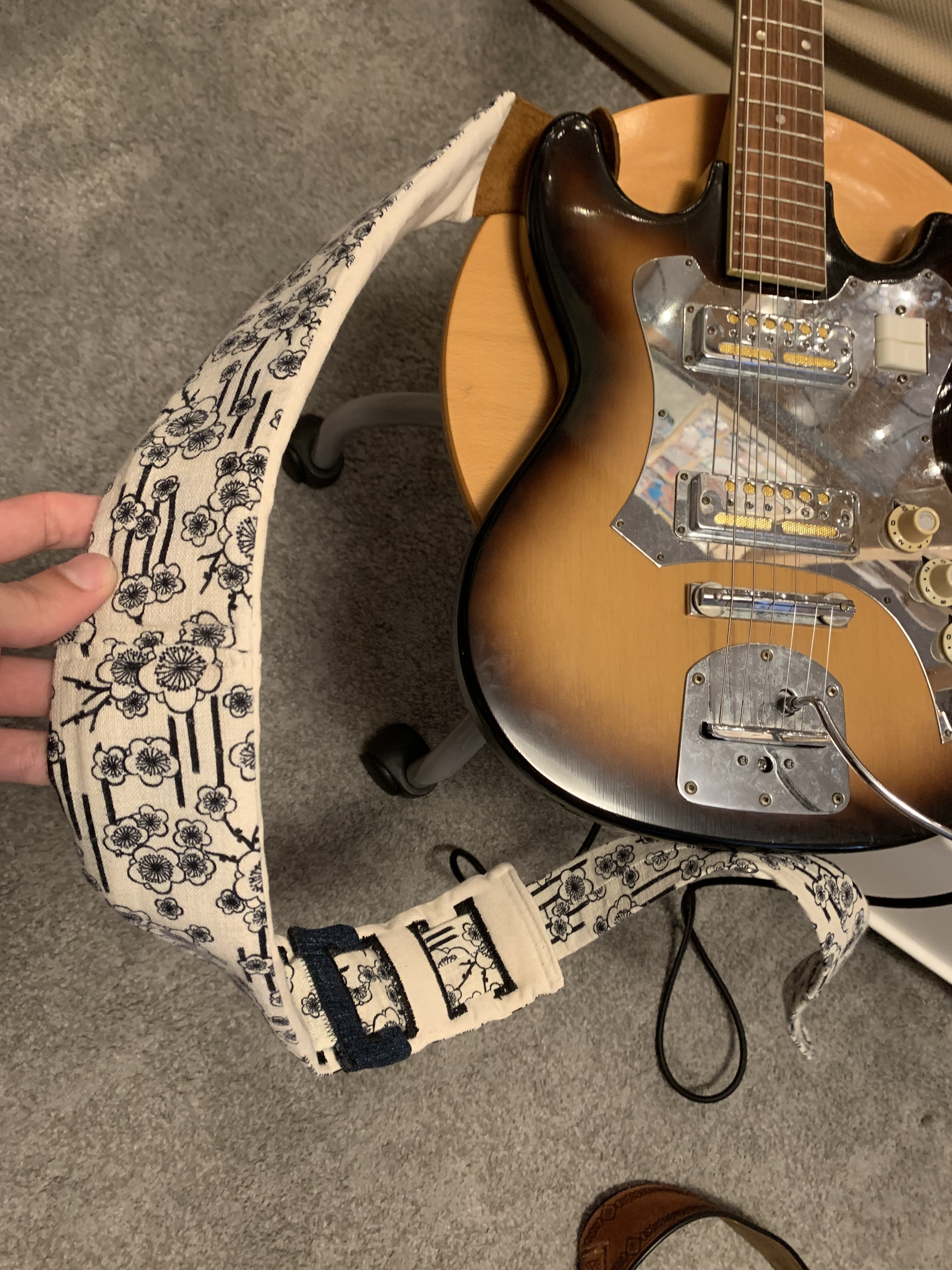 Alex's guitar with a hand-sewn guitar strap attatched